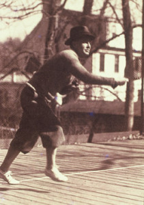 Caption: James K. Cogswell on the first platform paddle tennis court erected on his property